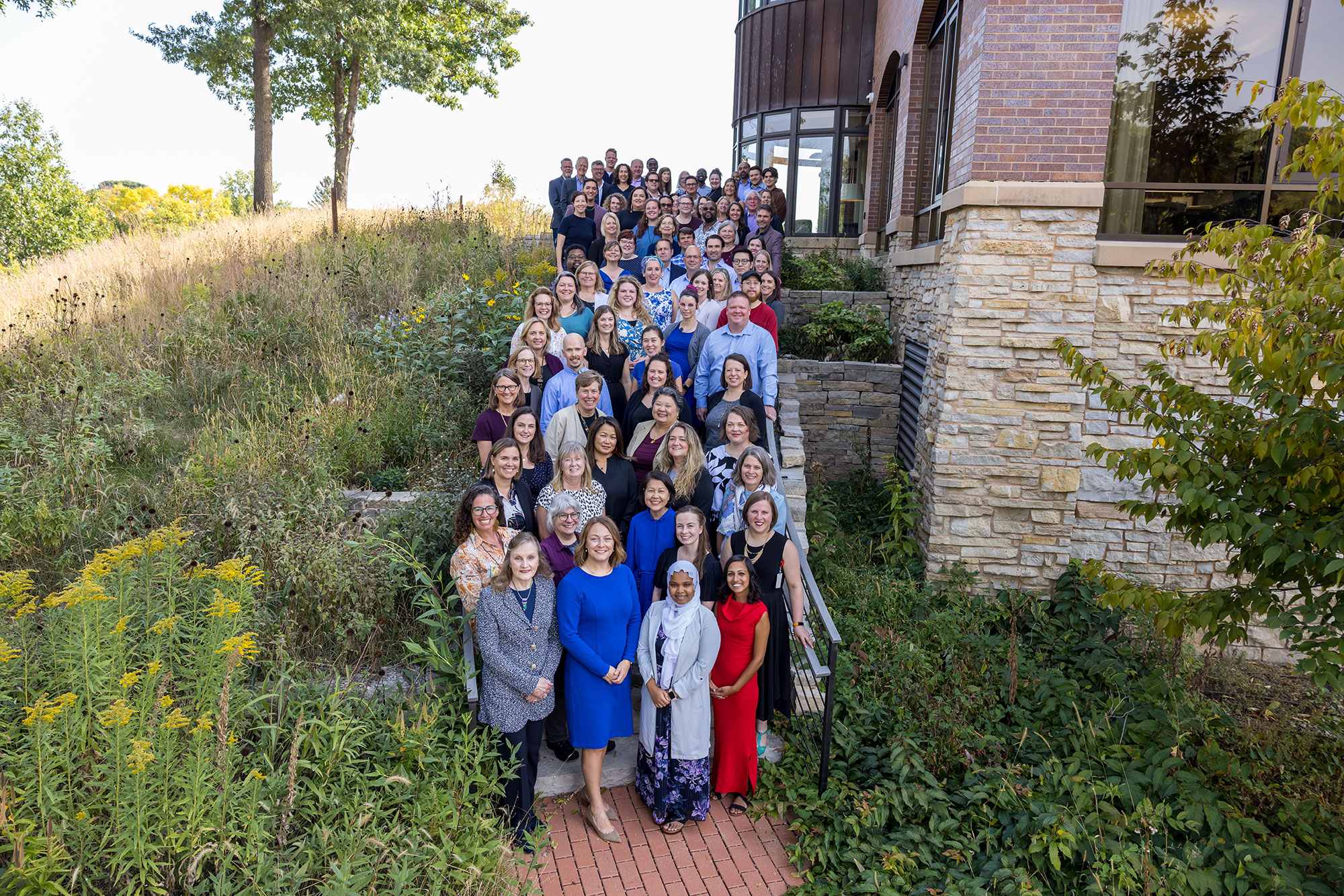 Photo of the full staff of MACP outside on a sunny day.